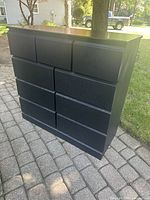 Front view of black nine-drawer dresser
