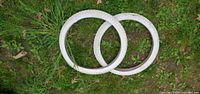Two white 20-inch BMX tires full view on grass