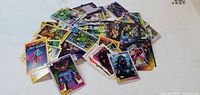 Pile of assorted Marvel trading cards showing various characters and border styles