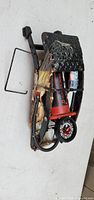 Full view of foot-pedal pump showing frame, cylinder, hose, and gauge