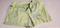 Front view of green shorts showing drawstring and overall appearance