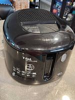 Front and top view of T-fal Filtra One deep fryer showing exterior condition and controls