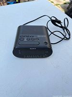 Front and top view of Sony ICF-C218 clock radio with attached power cord