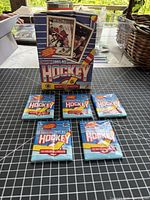 Five sealed 1991-92 O-Pee-Chee hockey wax packs displayed with retail box behind (box not included)