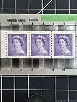 Front view of three purple 4-cent Canada stamps in strip form