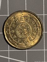 Obverse of coin showing Portuguese royal seal design
