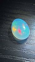 Top view of oval Ethiopian crystal opal showing multicolored fire