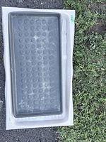 Dark gray tray nested in light gray tray showing size and designs