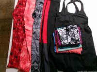 Assorted leggings and black tank laid flat