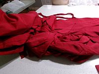 Folded red sofa cover showing attached ties