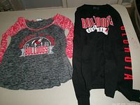 Both shirts laid flat showing front graphics