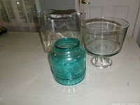 All three glass items grouped: rectangular vase, teal jar, pedestal dish