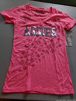 Full view of pink Aggies T-shirt front