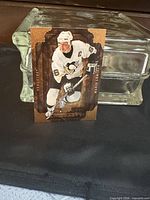 Front of Mario Lemieux Artifacts gold card displayed upright