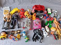 Full layout of all action figures, vehicles and accessories on grey background