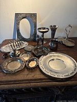 All silver-tone items arranged on wooden surface