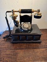 Full view of rotary phone on wooden surface