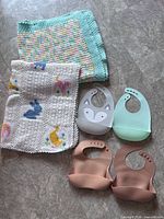 All items together – two blankets folded, four bibs displayed