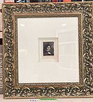 Full view of ornate gilt frame and matted etching print