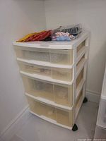 white plastic four-drawer storage unit on wheels