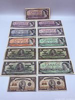 Front view of all banknotes showing denominations, colours and portraits