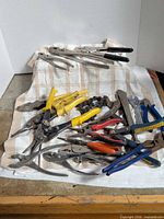 Full lot overview of assorted hand tools on cloth