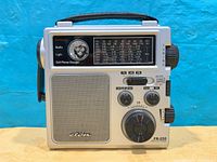 Front view of Eton FR-250 radio showing controls, speaker, emergency light and branding