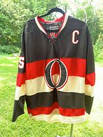 Front view showing logo, stripes, captain patch, lace collar