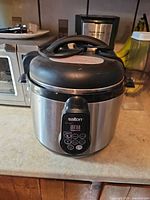 Front view of Salton stainless steel rice/multi-cooker showing digital control panel and exterior condition