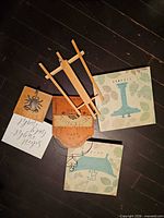 All items laid out: Welcome plaque, easel, crab hook block, two canvases, script sign