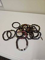 Pile of wooden beaded stretch bracelets on tabletop