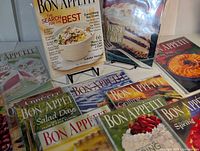 Group of Bon Appétit magazines on tabletop with two issues on stands