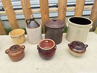 Group shot of all seven stoneware and ceramic vessels on table