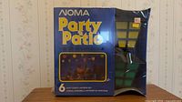 Front of sealed Noma Party 'n Patio lantern set box showing product name and window revealing lantern colours