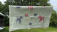 full view of quilt front showing animal appliqués