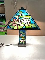 Lamp lit, showing stained glass shade and base design