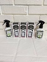 Group shot of all five odor sprays: three boxed Poo-Pourri and two Pet-Pourri bottles