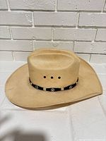Front view of Stetson straw cowboy hat showing crown shape and hatband
