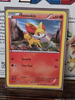 Front of Fennekin holographic card showing artwork and stats