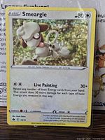 Front view of Smeargle 15/15 holo card in sleeve