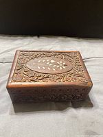 Top view showing carved lid and oval white inlay