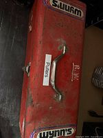 Closed red toolbox top view with stickers