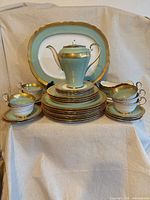 Front view showing complete mint green and gold Aynsley china service