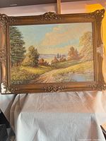 Full view of framed landscape painting