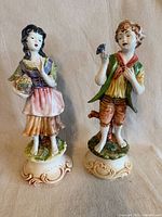Front view of both figurines on bases