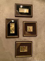 Four framed miniature gold-leaf artworks grouped on wall