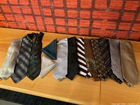 All 11 neckties and 2 pocket squares laid out for full view