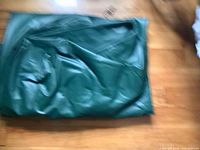 Folded green Coleman air mattress overall view