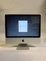 Front view of iMac powered on displaying setup screen