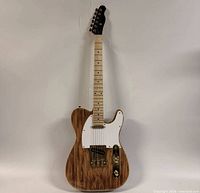 Front view of guitar showing spalted top, white pickguard, gold hardware